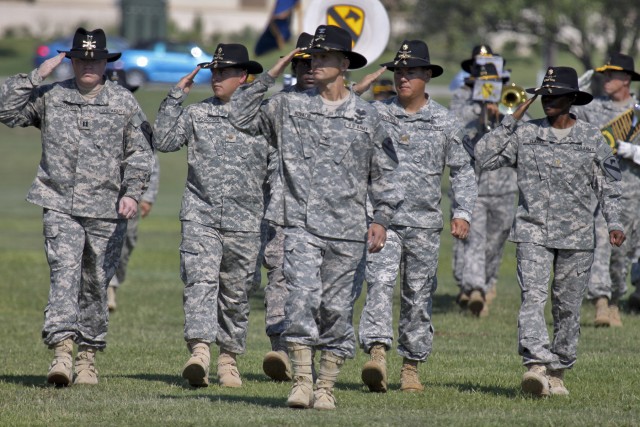 FORT HOOD, Texas-Col. John Novalis II (center), the newly-minted commander of the 1st Air Cavalry Brigade, 1st Cavalry Division, from Willamsport, Pa., salutes Brig. Gen. Daniel Allyn (off frame left), commander of the 1st Cav. Div., as he leads...
