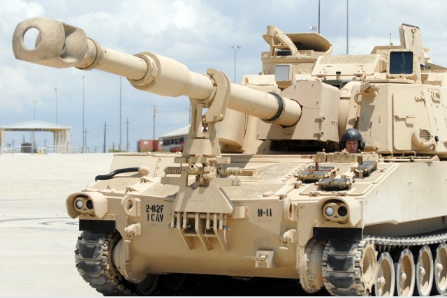 FORT HOOD, Texas-Spc. Robert Jones, from Halls, Tenn., sticks his head out of the driver hatch of a 155mm "Paladin" howitzer during B Battery, 2nd Battalion, 82nd Field Artillery, 1st Cavalry Division's maneuvering training at Fort Hood's...