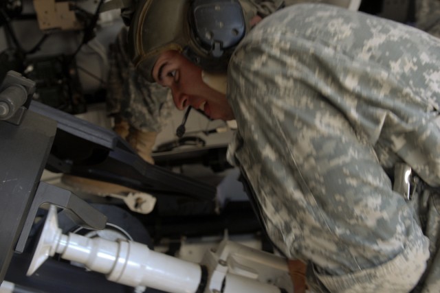 FORT HOOD, Texas-Pfc. David Spearman, from Longview, Texas, demonstrates how to load a round into the tube of a 155mm "Paladin" howitzer during B Battery, 2nd Battalion, 82nd Field Artillery, 1st Cavalry Division's training at Fort Hood's...