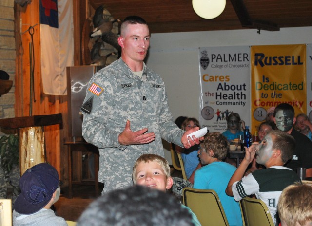 Soldier shares experiences with military camp kids