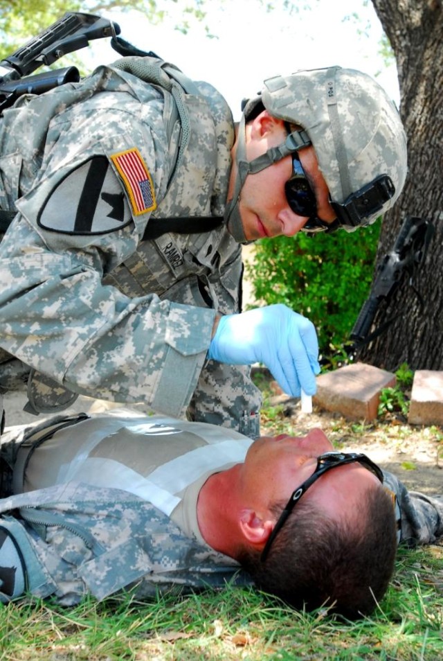 FORT HOOD, Texas- Spc. Juan Ramirez, a West Palm Beach, Fla., native and medic with 2nd Special Troops Battalion, 2nd Brigade Combat Team, 1st Cavalry Division, checks the eyes of Pfc. Robert Sellers, from Palm Bay, Fla., during training for the...