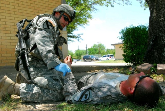 FORT HOOD, Texas- Spc. Juan Ramirez, from West Palm Beach, Fla., a medic with 2nd Special Troops Battalion, 2nd Brigade Combat Team, 1st Cavalry Division, checks the pulse of Pfc. Robert Sellers, from Palm Bay, Fla., during training for the Expert...