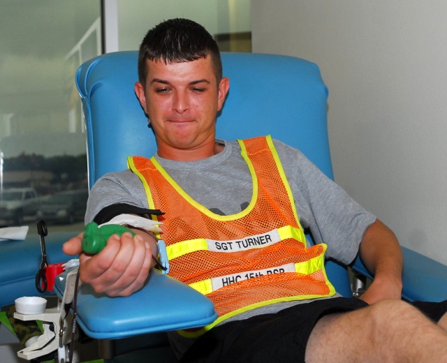 FORT HOOD, Texas- Sgt. Stephen Turner, a Locust Grove, Okla. native, 15th Brigade Support Battalion, 2nd Brigade Combat Team, 1st Cavalry Division, squeezes a foam grenade to increase the flow of his donation during the battalion's blood drive at...