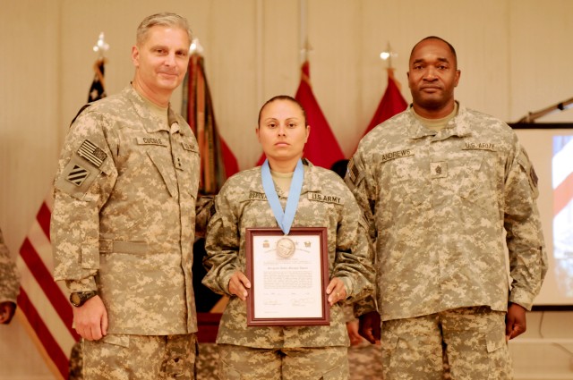 Task Force Marne Commanding General and Command Sergeant Major, Maj. Gen. Tony Cucolo, and Command Sgt. Maj. Jesse Andrews present the Sgt. Audie Murphy award to Sgt. Sandra Ospina, a military police officer with Headquarters and Headquarters Company...