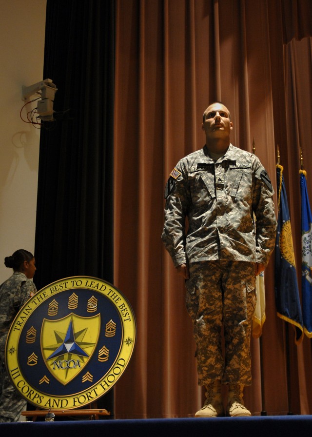 FORT HOOD, Texas - Sgt. Keith Bonner Jr., from Lakeland, Fla., a hydraulics mechanic for Company D, 2nd General Support Aviation Battalion, 227th Aviation Regiment, 1st Air Cavalry Brigade, 1st Cavalry Division, stands on stage before graduating...