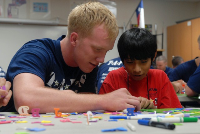 FORT HOOD, Texas - Clarksville, Tenn. Native, Pfc. Robert Landwehr, a nuclear, biological and chemical Soldier, assigned to the 2nd Battalion, 8th Cavalry Regiment, 1st Brigade Combat Team, 1st Cavalry Division, assists his mentoree, Eric Vega,...