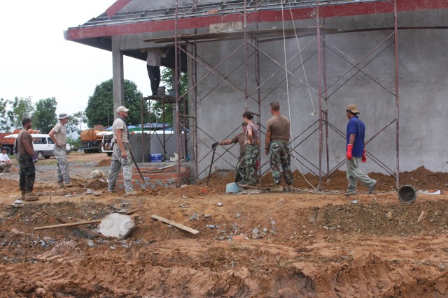Utah and Cambodian Soldiers guard children&#039;s safety
