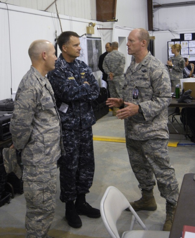 FORT A.P. HILL, Va. – U.S. Air Force Brig. Gen. Robert Nolan, Joint Task Force – National Scout Jamboree commander (right), and U.S. Air Force Col. Vick Dallin, the Joint Multi-agency Operations Coordination Center director (far left), explain...