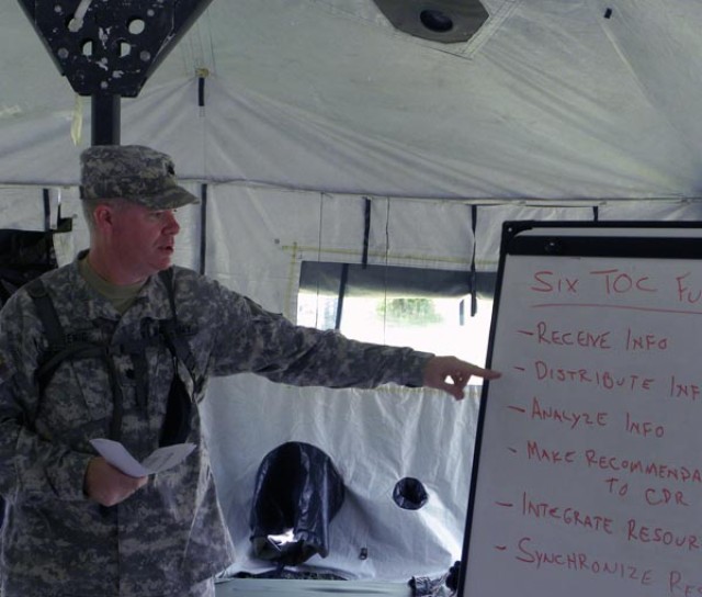 Lt. Col. Douglas Hoenig, executive officer, 533rd Engineer Detachment, Forward Engineer Support Team - Main reviews six functions of a tactical operations center during a field exercise June 23-25 at Fort Knox, Ky. The exercise tested the Corps team ...