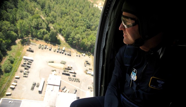 U.S. Air Force Lt. Col. Scott Drinkard, a member of the U.S. Air Force Academy Wings of Blue Jump Team, looks down at set-up procedures while on a U.S. Army UH-60 Black Hawk helicopter July 25. The team will perform at the Boy Scouts of America’s 201...
