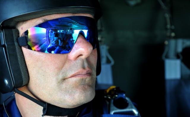 Steve Archuletta, a member of the U.S. Air Force Academy Wings of Blue Jump Team, looks down at set-up procedures while on a U.S. Army UH-60 Black Hawk helicopter July 25. The team will perform at the Boy Scouts of America’s 2010 National Scout Jambo...