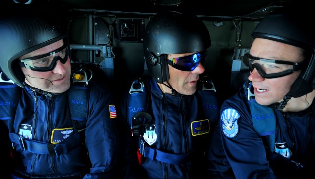 (L to R) Lt. Col. Scott Drinkard, Steve Archuletta and Cadet Jesse Galt, members of the U.S. Air Force Academy Wings of Blue Jump Team, converse during a U.S. Air Force Academy Wings of Blue Jump Team demonstration run July 25. The team will...