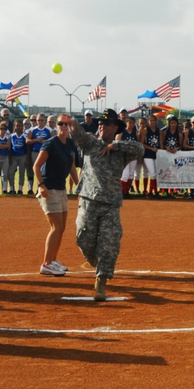 FORT HOOD, Texas-Col. John Peeler, commander of the 2nd Brigade Combat Team, 1st Cavalry Division, Fort Hood, throws the first pitch during the opening ceremony for the 2010 Amateur Softball Association's 14 and under, B-Girls Fast Pitch Southern Nat...