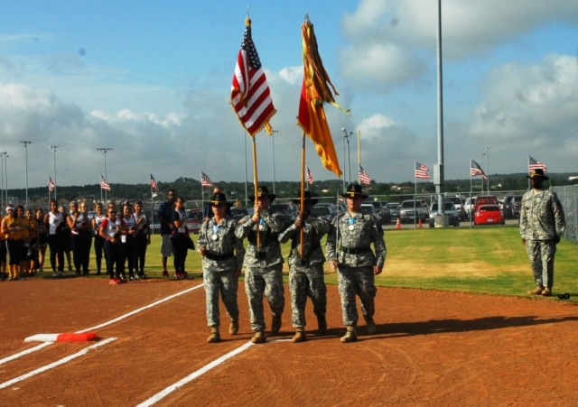 FORT HOOD, Texas-The 2nd Brigade Combat Team, 1st Cavalry Division\'s Sergeant Audie Murphy Color Guard march to home plate during the opening ceremony for the 2010 Amateur Softball Association's 14 and under B-Girls Fast Pitch Southern National Tour...