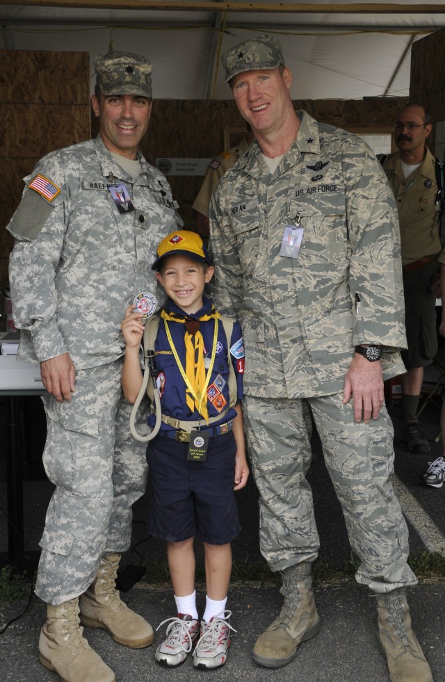 
U.S. Army Lt. Col John W. Haefner, Fort A.P. Hill commander, and his son Luke pose for a photo with U.S. Air Force Brig. Gen. Robert Nolan, Joint Task Force-National Scout Jamboree commander, in the VIP tent at the Boy Scouts of America’s National S...