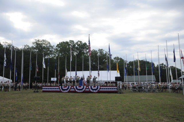 U.S. Army Lt. Col John W. Haefner, Fort A.P. Hill commander, his son Luke, and U.S. Air Force Brig. Gen. Robert Nolan, Joint Task Force-National Scout Jamboree commander, salute the colors as the Rhode Island 88th Army Band performs at the Boy Scouts...