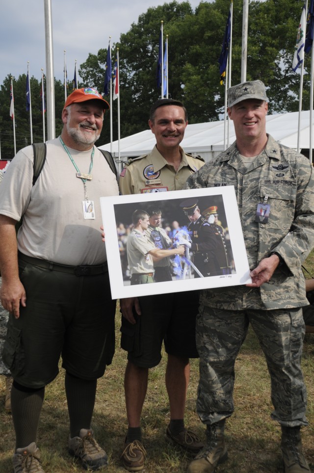 Air Force Brig. Gen. Robert Nolan, Joint Task Force-National Scout Jamboree commander, showcases the “photo of the day” alongside Scout leaders at the Boy Scouts of America’s National Scout Jamboree opening flag ceremony in the Heth Area’s Court of F...