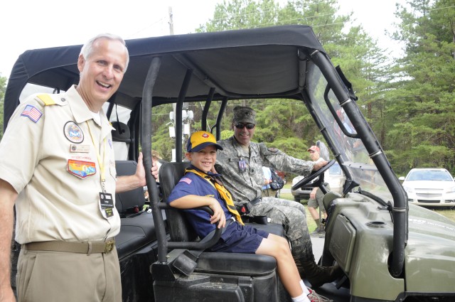 Army Lt. Col John W. Haefner, Fort A.P. Hill commander, his son Luke, pose for a photo with Jim Barbieri, Boy Scouts of America National Scout Jamboree VIP chairman, during the BSA’s NSJ July 27. Colonel Haefner spent the morning touring the...