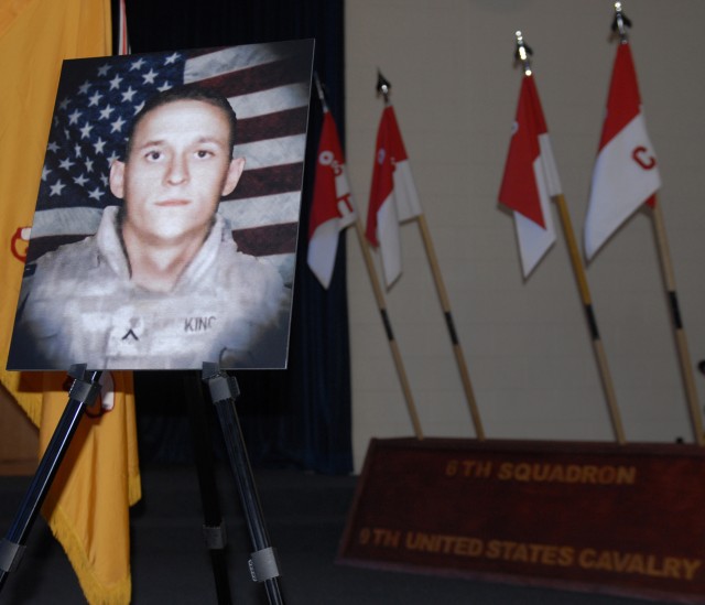 FORT HOOD, Texas - A poster-sized photo of Pvt. Charles Paul King,  sits at the front of the 1st Cavalry Division's Memorial Chapel as Family members and Soldiers from 6th Squadron, 9th Cavalry Regiment, 3rd Brigade Combat Team, 1st Cavalry Division,...