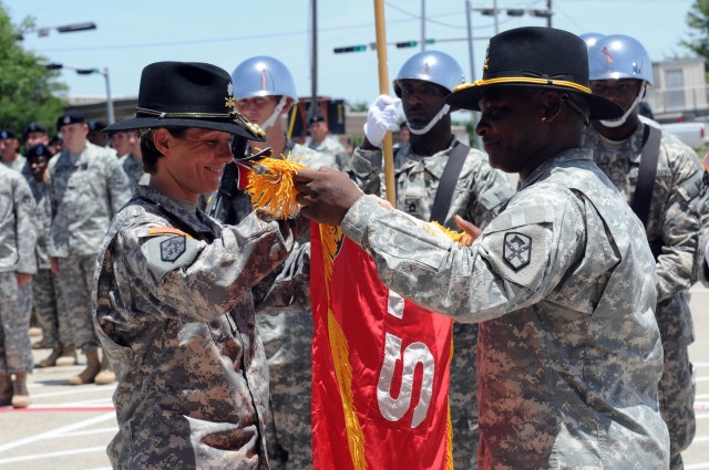 Lt. Col. Paula Lodi, commander, and Master Sgt. Donald Hutchinson, rear detachment senior noncommissioned officer, 15th Special Troops Battalion, 15th Sustainment Brigade, 13th Sustainment Command (Expeditionary) uncases the Wranglers' colors...