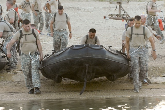 FORT HOOD, Texas - Soldiers from 3rd Brigade Combat Team, 1st Cavalry Division carry their zodiac watercraft into Cow House Creek and prepare to paddle three-and-a-half miles as part of a physical fitness challenge lead by the brigade's command...