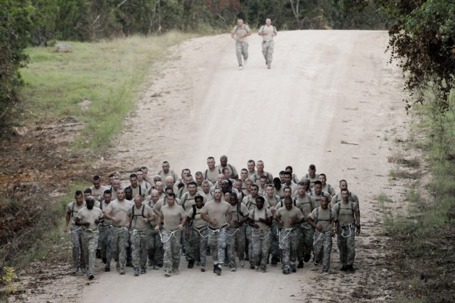 FORT HOOD, Texas - Col. Douglas Crissman (front left) and Command Sgt. Maj. James Pippin, 3rd Brigade Combat Team, 1st Cavalry Division, lead Soldiers on a three-mile run at Fort Hood's Training Area 8 during a physical fitness training challenge...