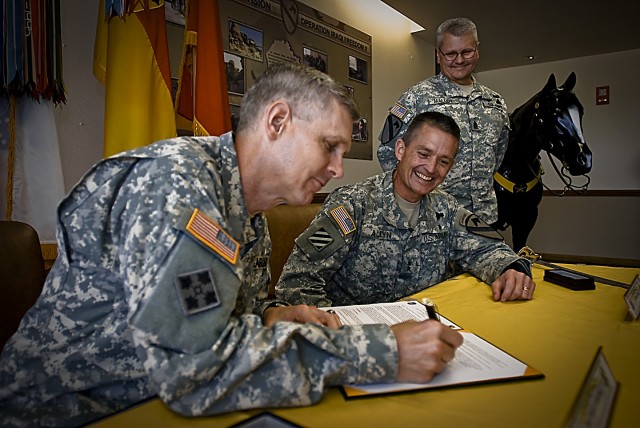 FORT HOOD, Texas- Commander of the United States Recruiting Command, Maj. Gen. Donald Campbell, signs the Memorandum of Agreement between the 1st Cavalry Division and USAREC, as Maj. Gen. Daniel Allyn, 1st Cav. Div. commander, and Division Command...