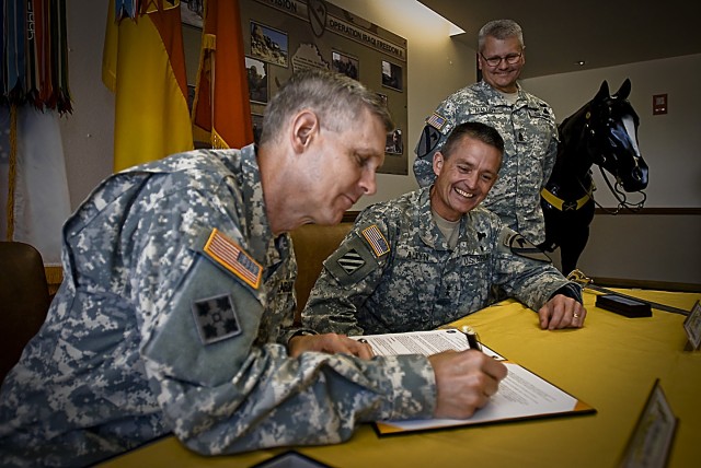 FORT HOOD, Texas- Commander of the United States Recruiting Command, Maj. Gen. Donald Campbell, signs the Memorandum of Agreement between the 1st Cavalry Division and USAREC, as Maj. Gen. Daniel Allyn, 1st Cav. Div. commander, and Division Command Sg...