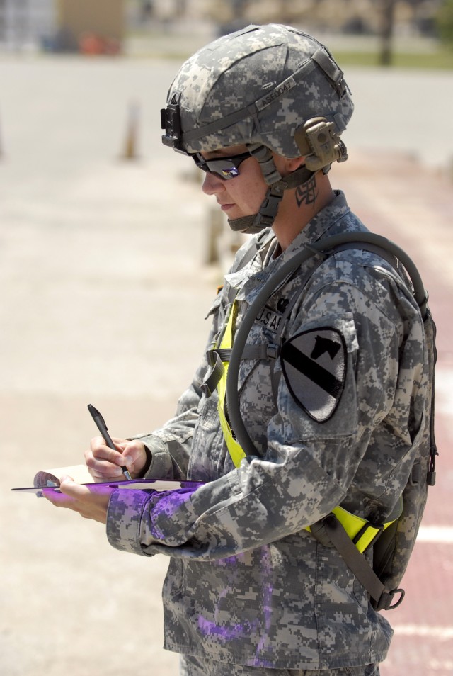 FORT HOOD, Texas- Sgt. Samantha French, a native of Potsdom, N.Y., assigned to the 27th Brigade Support Battalion, 4th Brigade Combat Team, 1st Cavalry Division, annotates the weight and container number of equipment the brigade is shipping to...