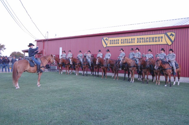 FORT HOOD, Texas -A trooper assigned to the 1st Cavalry Division Horse Detachment shows battalion commanders from 4th Brigade Combat Team, 1st Cavalry Division, how to hold the reigns of their mounts during a safety briefing  prior to participating i...