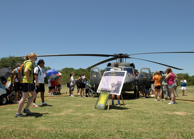 KILLEEN, Texas - Campers and staff of Camp Soaring Eagle at Peaceable Kingdom Retreat for Children gather around a Black Hawk helicopter flown in by a crew from Company C, 3rd Assault Helicopter Battalion, 227th Aviation Regiment, 1st Air Cavalry...