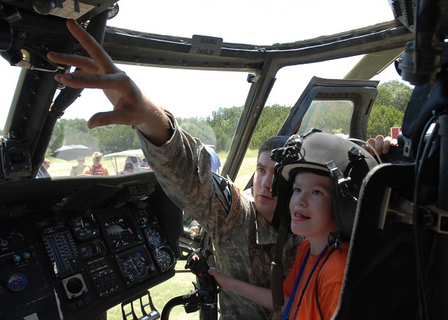 KILLEEN, Texas -  Sgt. Shawn Hussey (left), from Atkinson, N.H., a crew chief for Company C, 3rd Assault Helicopter Battalion, 227th Aviation Regiment, 1st Air Cavalry Brigade, 1st Cavalry Division, points out different controls of a Black Hawk to...