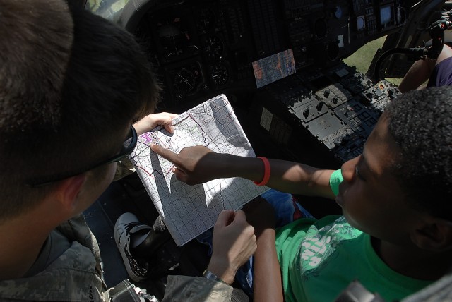 KILLEEN, Texas -  Chief Warrant Officer 2 Joshua Aronack (left), from Houston, a Black Hawk pilot with Company C, 3rd Assault Helicopter Battalion, 227th Aviation Regiment, 1st Air Cavalry Brigade, 1st Cavalry Division, shows Prinzzz Purnell...