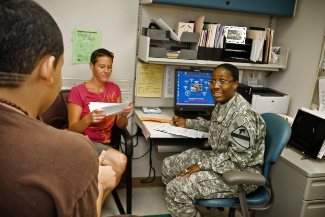 FORT HOOD, Texas-Ripley, Tenn. Native, Maj. Marolyn Pearson (right), senior division physician's assistant for the 1st Cavalry Division, asks routine health questions to her patient during a sports physical and health assessment, here, at the Thomas ...