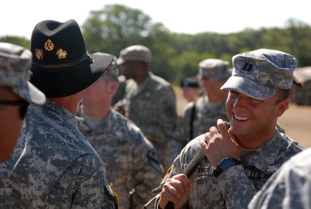 FORT HOOD, Texas - Capt. Tyler Cortner (right), from Tulsa, Okla., the commander of Company C, 1st Brigade Special Troops Battalion, 1st Brigade Combat Team, 1st Cavalry Division, receives congratulations for earning the Army's Expert Field Medical B...