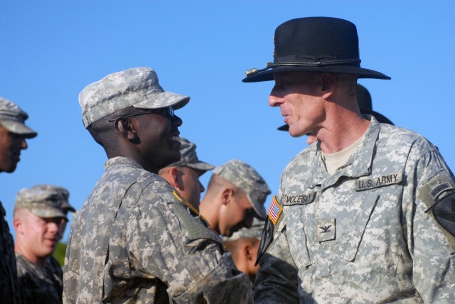 FORT HOOD, Texas - Col. Gary Volesky (right), former commander of 2nd Battalion, 5th Cavalry Regiment, and an Expert Infantry Badge holder, congratulates 1st Brigade Combat Team, 1st Cavalry Division Soldiers on their success completing the EIB cours...