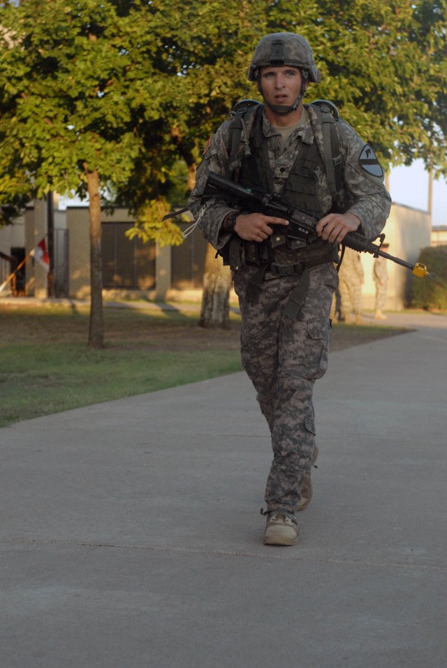 FORT HOOD, Texas - Columbia, Mo. native, Spc. Kyle Depriest, an infantryman assigned to Company B, 2nd Battalion, 8th Cavalry Regiment, 1st Brigade Combat Team, 1st Cavalry Division Soldier completes the12-mile ruck march to earn the Expert Infantry ...