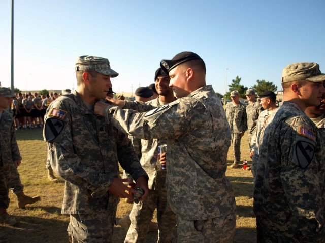 FORT HOOD, Texas - Los Angeles native, Capt. Anthony Mattazaro (left), the plans officer assigned to Headquarters and Headquarters Company, 2nd Battalion, 8th Cavalry Regiment, 1st Brigade Combat Team, 1st Cavalry Division, recieves the Expert Infant...