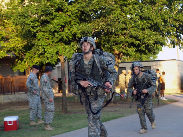 FORT HOOD, Texas - Brownsburg, Ind. native, Spc. Nicholas Borgeling, an infantry Soldier assigned to Company B, 2nd Battalion, 8th Cavalry Regiment, 1st Brigade Combat Team, 1st Cavalry Division, races to the finish line to complete the 12-mile ruck ...