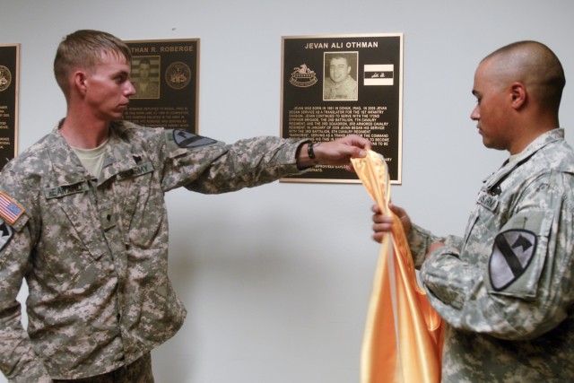 FORT HOOD, Texas-Spc. James Heaward (left) and Spc. Evan Arnold, both with Headquarters and Headquarters Company, 3rd Battalion, 8th Cavalry Regiment, 3rd Brigade Combat Team, 1st Cavalry Division, unveil the dedication plaque of Jevan Ali Othman, an...