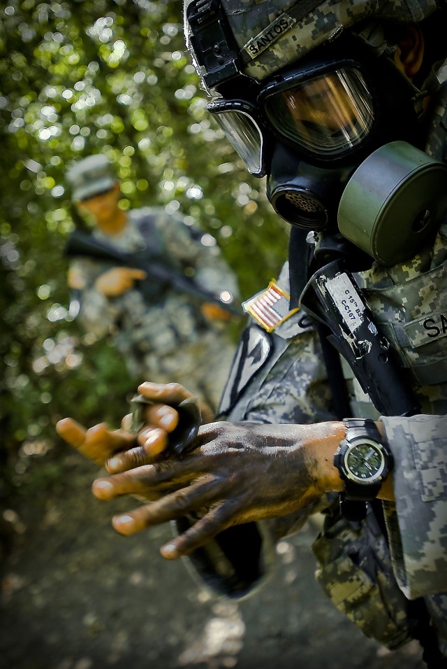 FORT HOOD, Texas-Spc. Jeffrey Santos, from Killeen, Texas, a medical supply Soldier with the 1st Brigade Combat Team, 1st Cavalry Division, simulates chemical decontamination of all exposed skin during the 1st Cav. Div.'s Expert Field Medical...