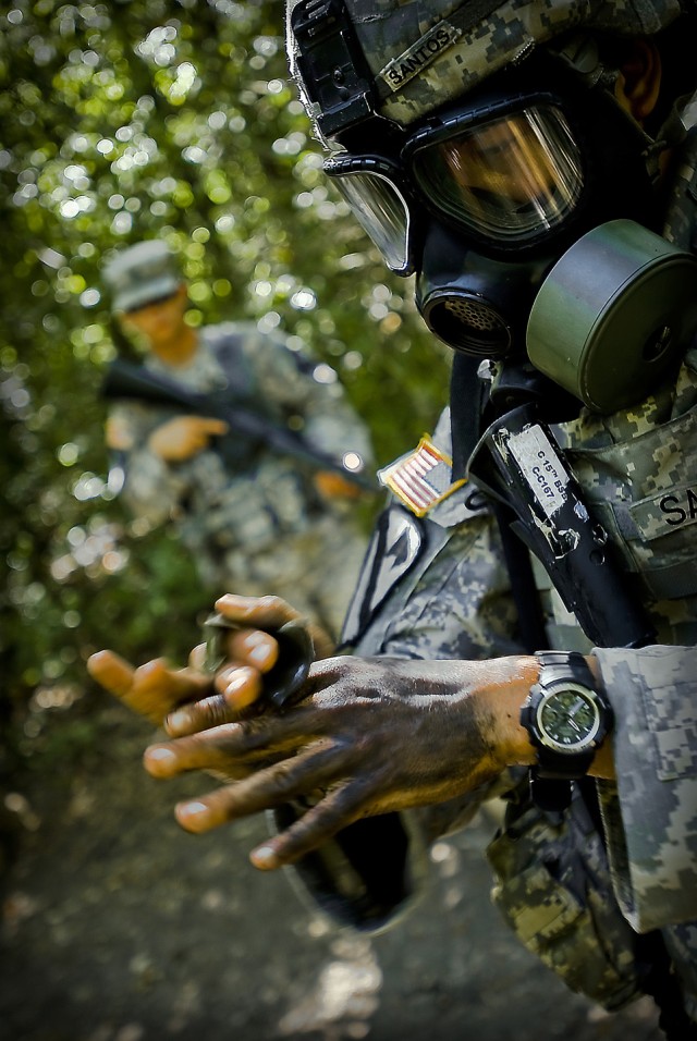 FORT HOOD, Texas-Spc. Jeffrey Santos, from Killeen, Texas, a medical supply Soldier with the 1st Brigade Combat Team, 1st Cavalry Division, simulates chemical decontamination of all exposed skin during the 1st Cav. Div.'s Expert Field Medical Badge C...