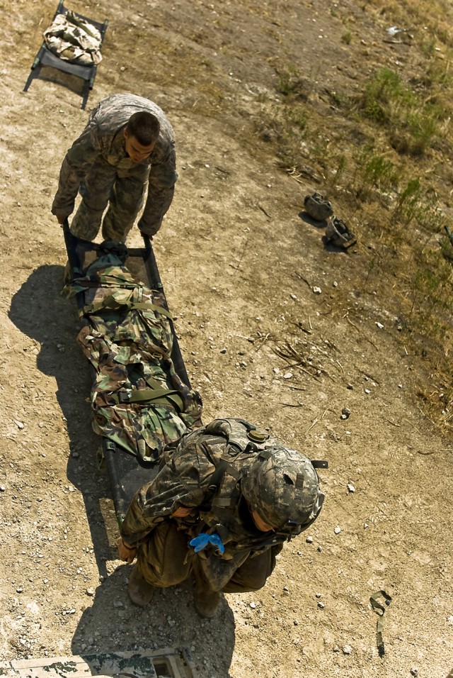 FORT HOOD, Texas-Freemont, Calif. Native, Sgt. Nathaniel Fielding (leading), a medical supply sergeant with 2nd Brigade Combat Team, 1st Cavalry Division,  carriers a simulated littered casualty to the door of an awaiting battlefield ambulance during...