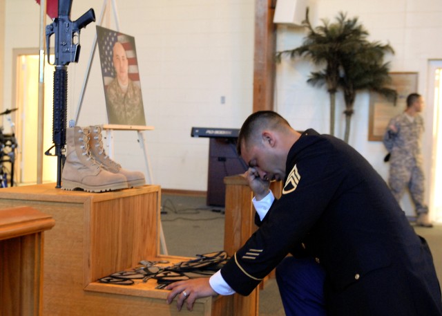 FORT HOOD, Texas - Staff Sgt. Karl Akama, from Honolulu, a platoon sergeant with C Company, 3rd Brigade Combat Team Special Troops Battalion, 1st Cavalry Division, takes a knee and has a moment of silent in front of Staff Sgt. Bradley Penman's...