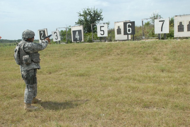 FORT HOOD, Texas-Staff Sgt. Gabriel Rivera, of San Antonio,Texas, a multiple launch rocket systems section chief for B Battery, 2nd Battalion, 20th Field Artillery Regiment, shoots his  9mm pistol during the 41st Fires Brigade's marksmanship competit...