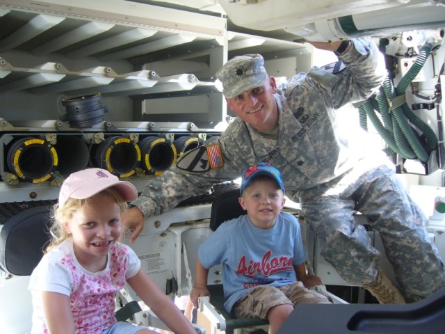 FORT HOOD, Texas-Lt. Col. Miles Brown, of Honea Path, S.C., commander, 1st Battalion, 82nd Field Artillery Regiment, 1st Brigade Combat Team, 1st Cavalry Division, stands by as his children receive instructions on the "Paladin" self-propelled...