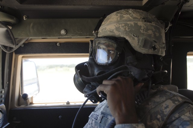 FORT HOOD, Texas-Sgt. Darren Woods, a recon security detachment member with 215th Brigade Support Battalion, 3rd Brigade Combat Team, 1st Cavalry Division, executes crew fire commands, Aug. 20, while wearing a gas mask as part of the brigade's...