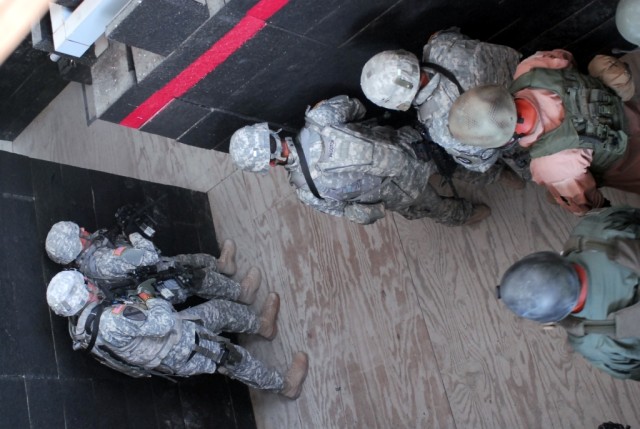 FORT HOOD, Texas- Military policemen from 2nd Special Troops Battalion, 2nd Brigade Combat Team, 1st Cavalry Division, practice stacking against the walls before clearing rooms during the Special Reaction Team phase one training at the Fort Hood...