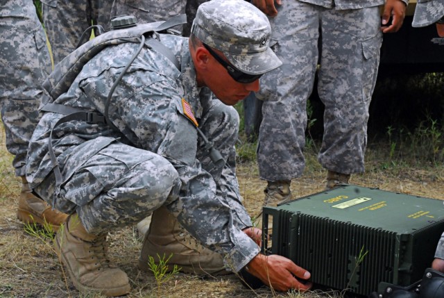 FORT HOOD, Texas-Pfc. Jeff Headman, a Minneapolis, Minn. native and a communications specialist with 2nd Special Troops Battalion, 2nd Brigade Combat Team, 1st Cavalry Division, helps set up a High-Capacity Line-of-Sight Radio during training,...