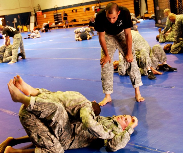 FORT HOOD, Texas -Level III certified basic instructor, Sgt. Parris Bussiere (standing), from Cape Cod, Mass., watches as Pfc. Bryant Moore (left), of Union Springs, Ala. attempts to pass the guard of Pfc. Nicholas Sawyer, from Hilsboro, Ore. at...